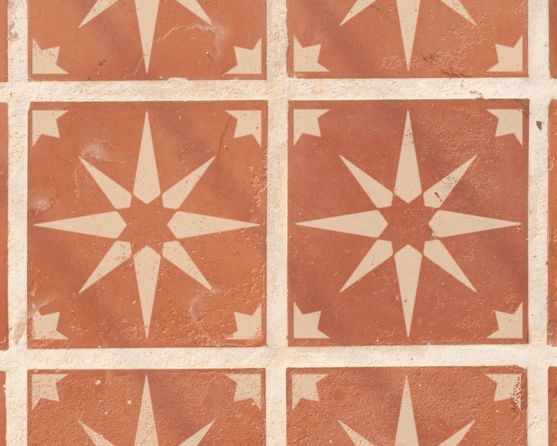 a pattern of red and white star-shaped tiles arranged in a grid-like design.