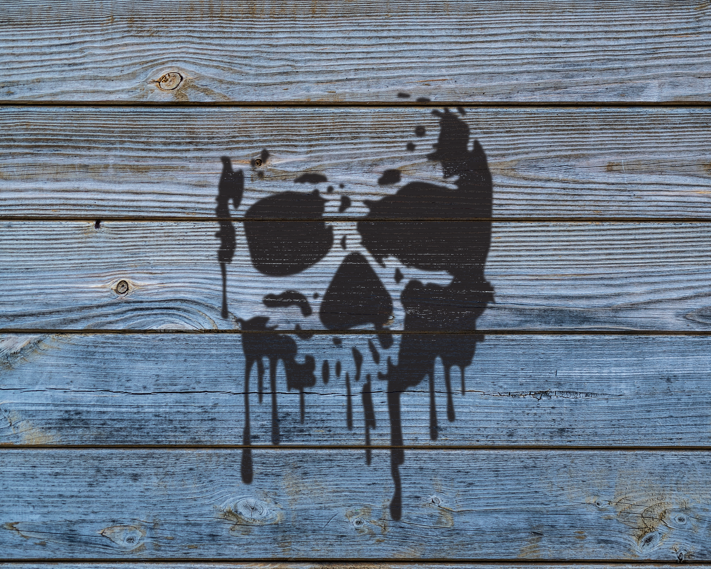 a wooden surface with a black, dripping, graffiti-like design resembling a skull or skull-like shape.