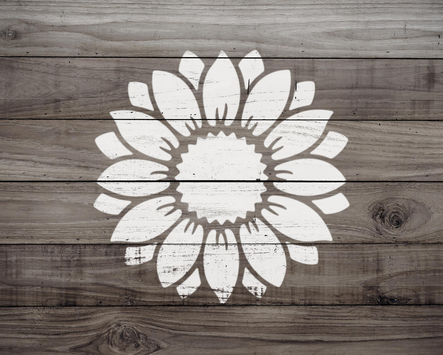 A white silhouette of a flower is centered on a wooden background.