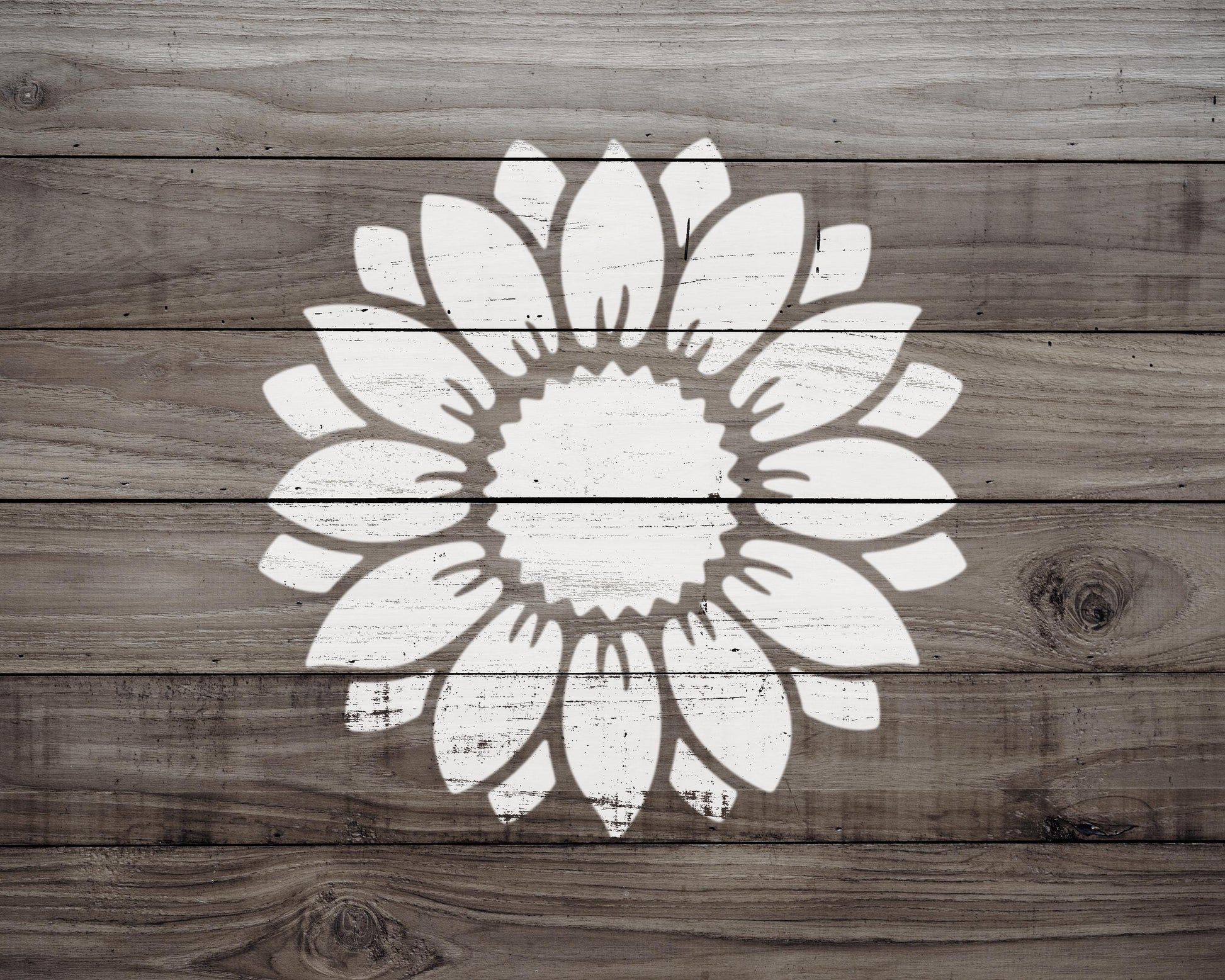 A white silhouette of a flower is centered on a wooden background.