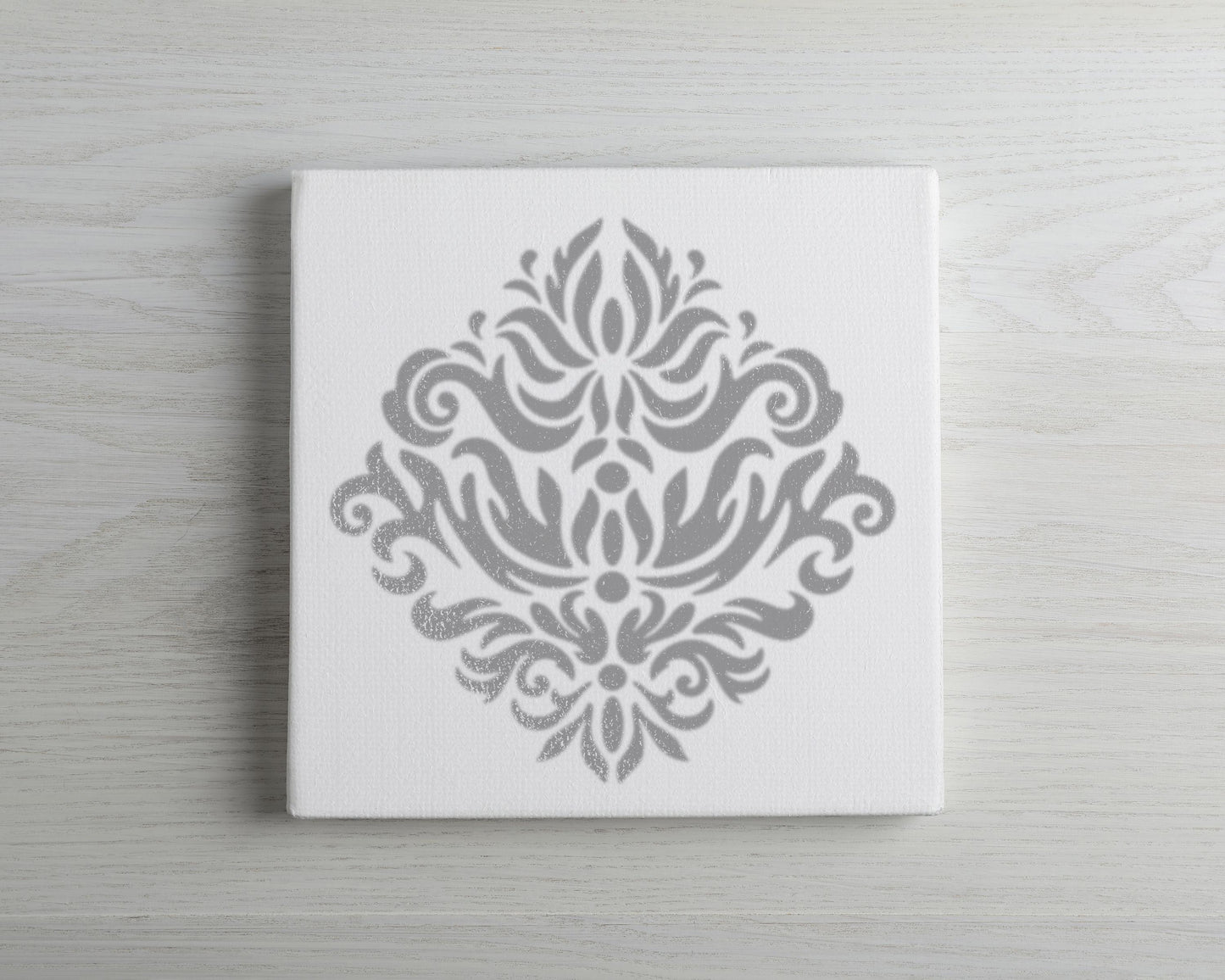 a white canvas with a decorative gray design on it.