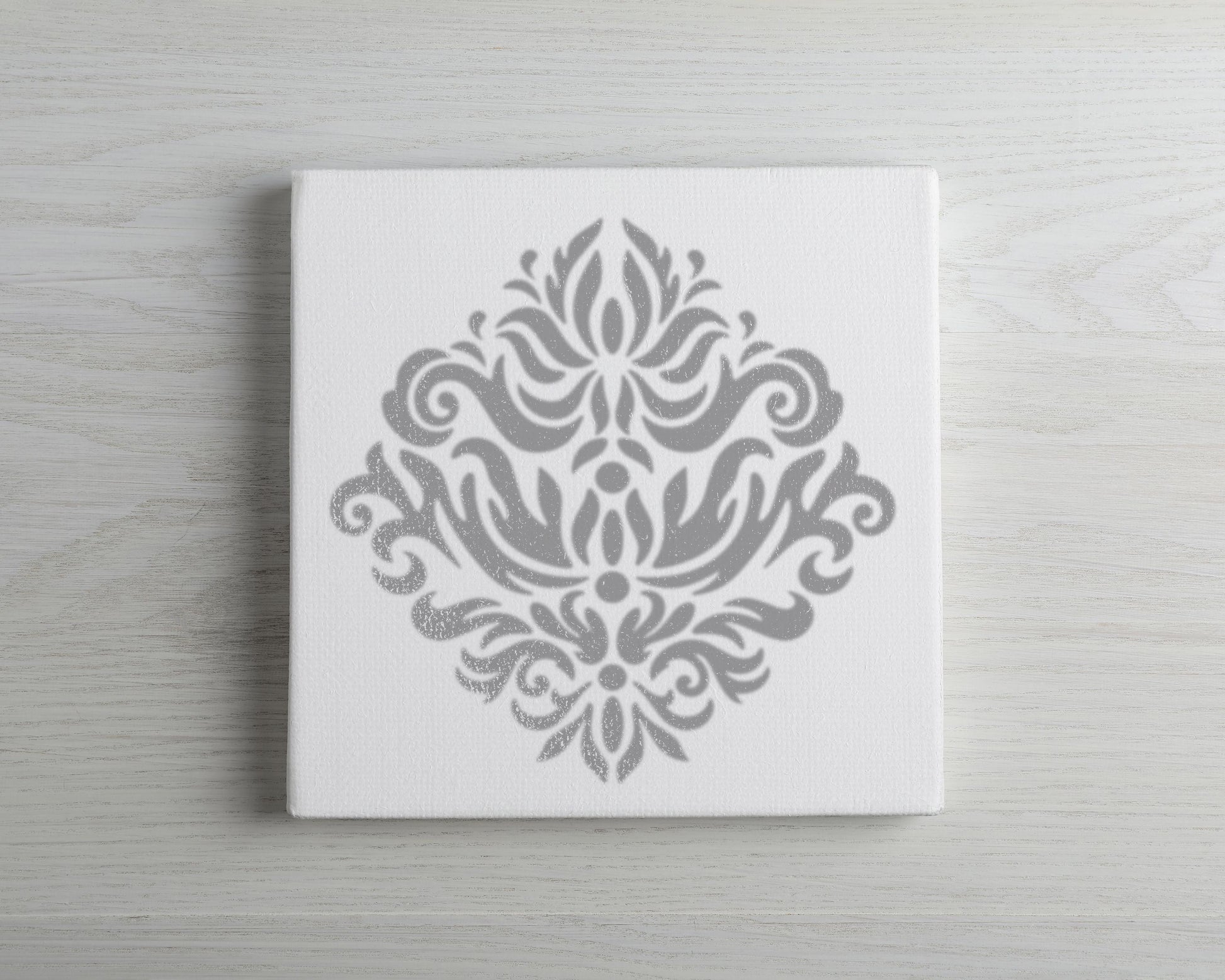 a white canvas with a decorative gray design on it.
