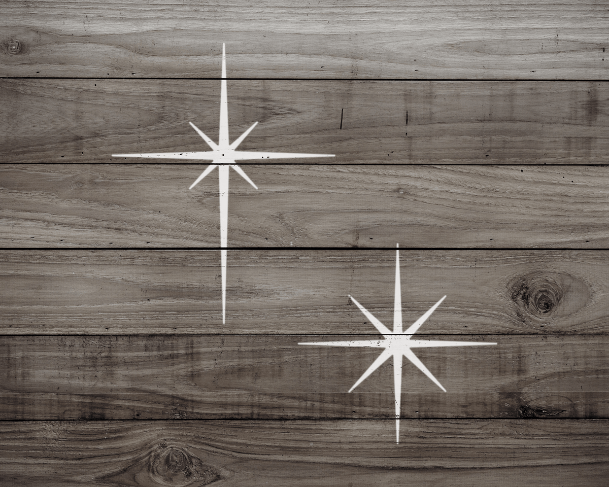 two white star-shaped designs on a wooden surface.