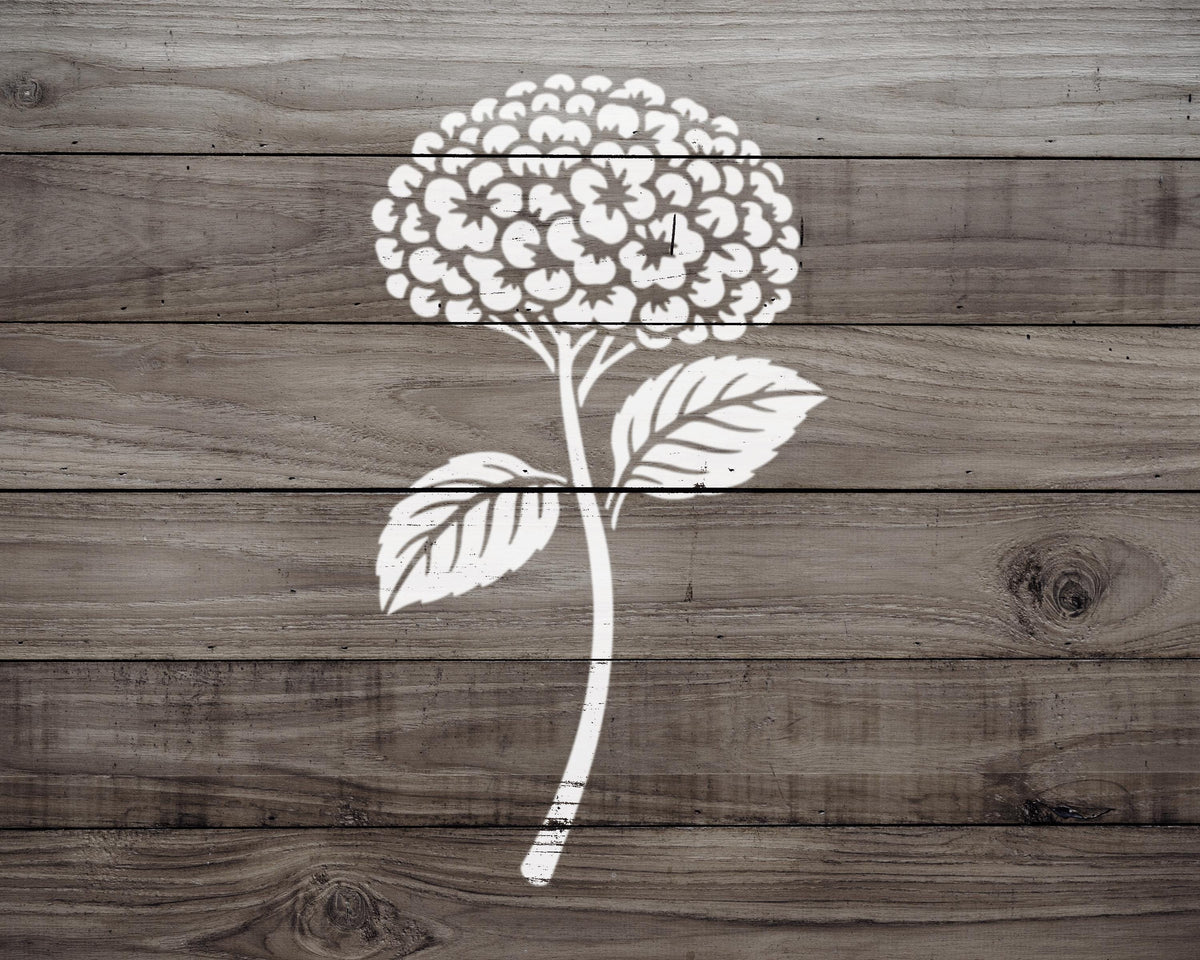 A white floral design is prominently displayed on a wooden background.