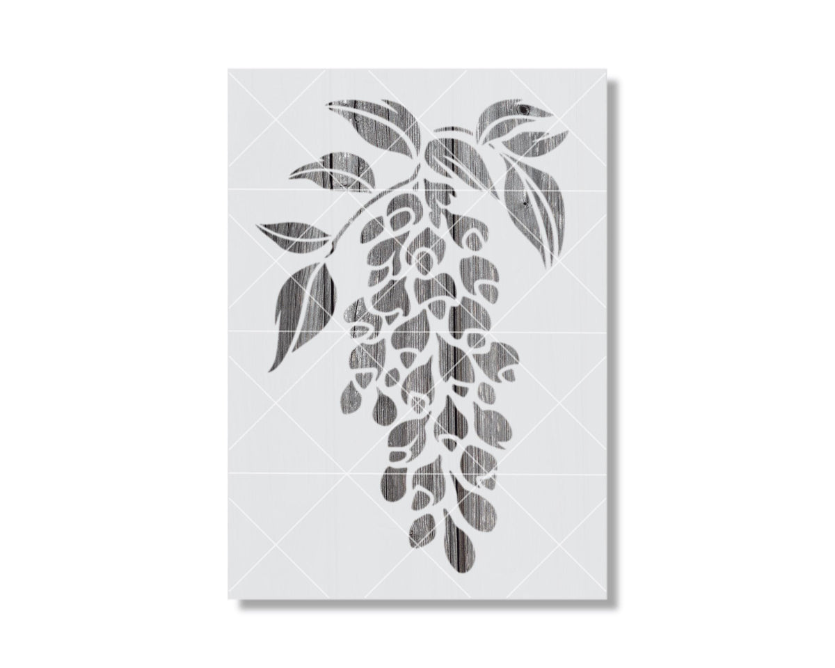 A black and white image depicting a stylized floral design with leaves and branches.