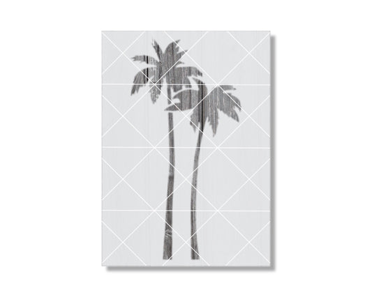 A black and white image of two palm trees with textured, weathered appearance.