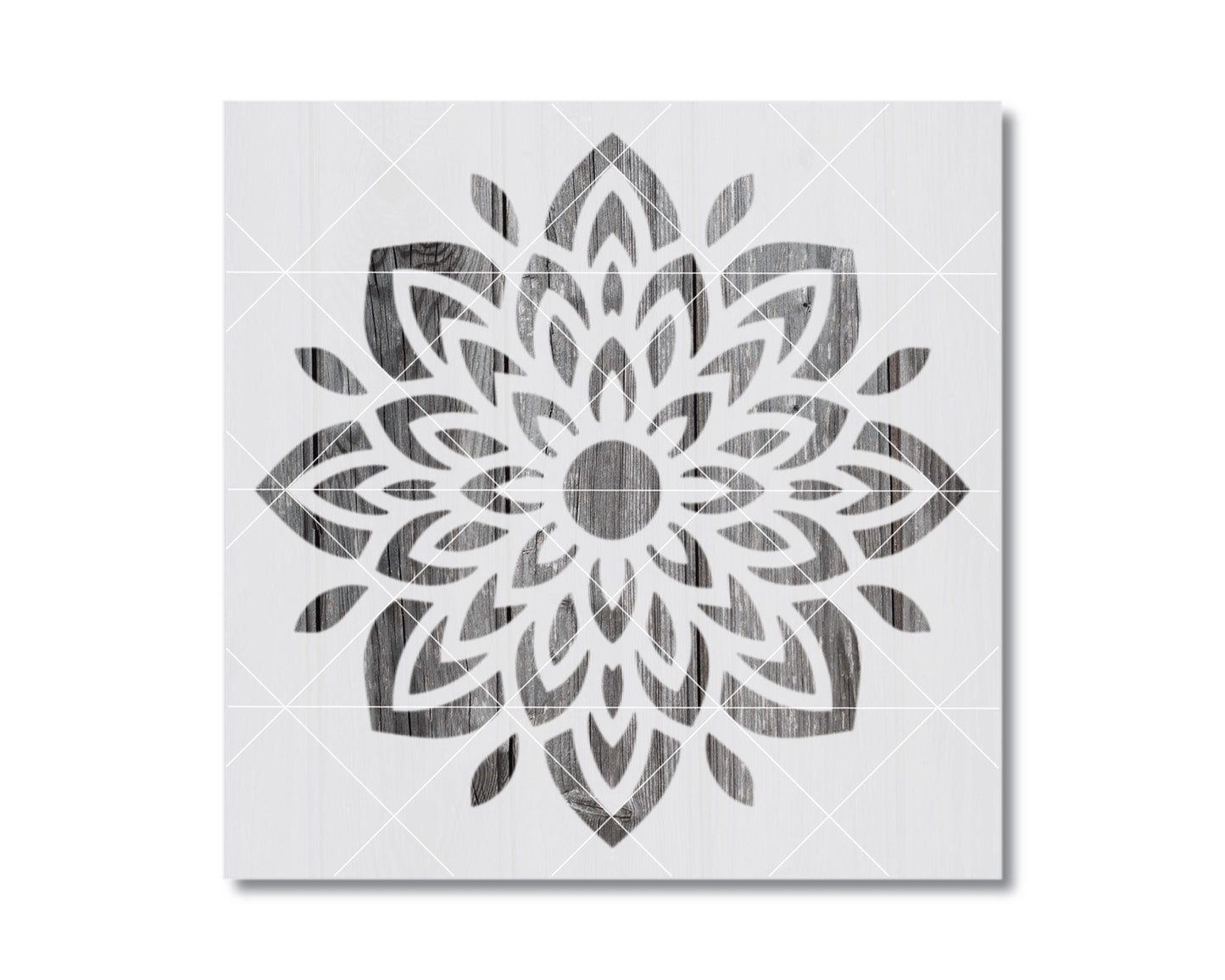 a symmetrical, intricate floral design with a central circle surrounded by a multitude of petals and leaves in a black and white color scheme.