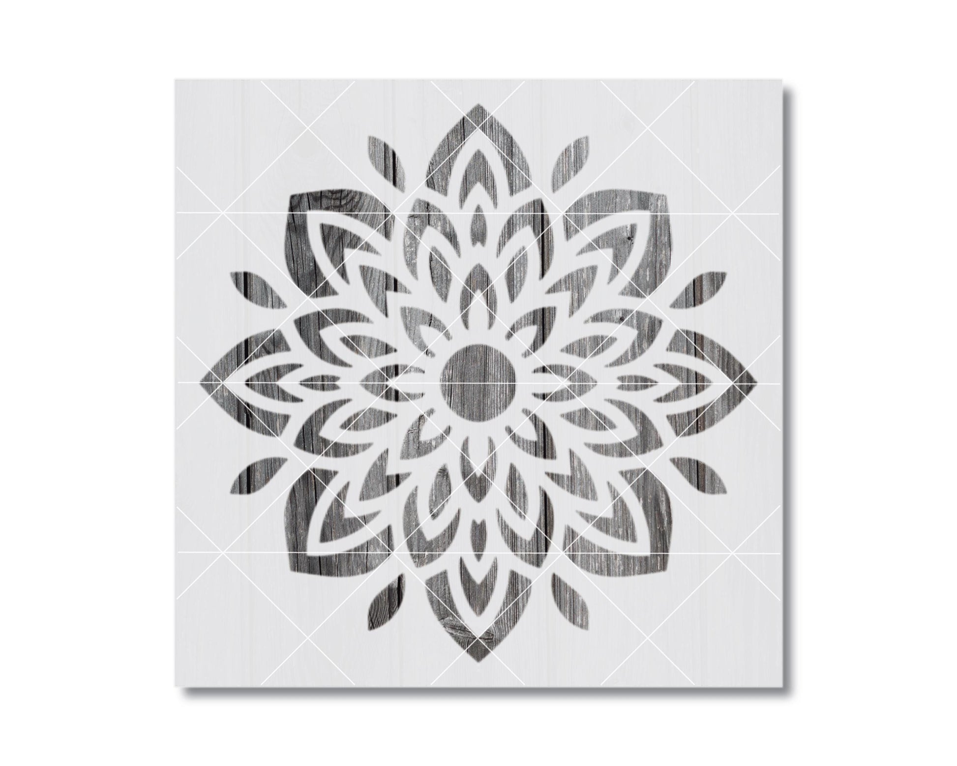 a symmetrical, intricate floral design with a central circle surrounded by a multitude of petals and leaves in a black and white color scheme.