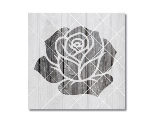 A black and white image of a rose on a wooden background.