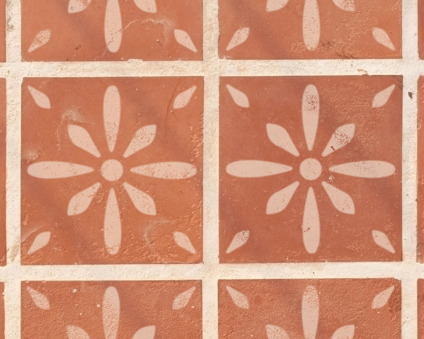 a close-up view of a patterned tile surface with a repeating design of white flowers or petals.