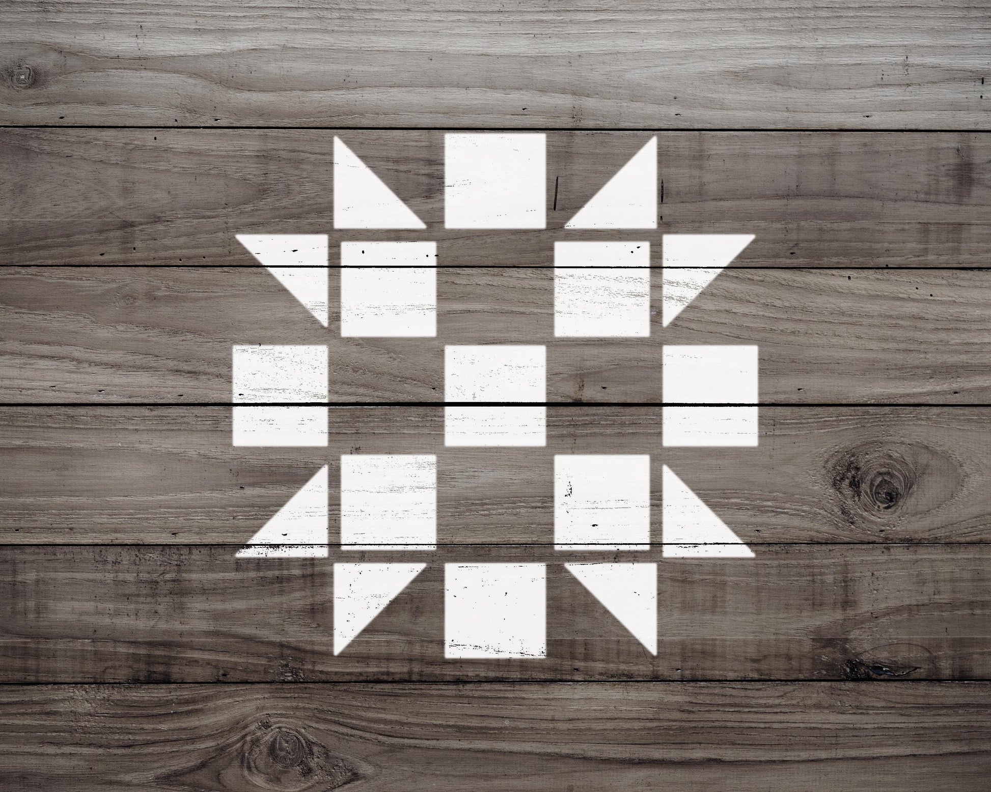 a wooden surface with a white geometric pattern composed of various shapes, including squares and triangles, creating a visually striking design.