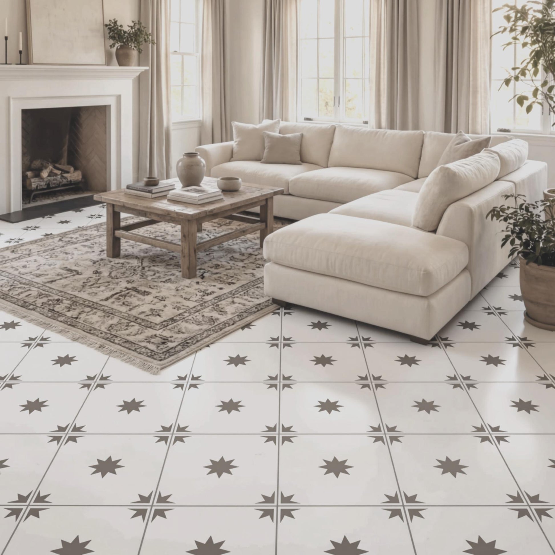 a cozy living room with a large sectional sofa, a wooden coffee table, and a fireplace. The room has a white tile floor with a star-shaped pattern, and there are several potted plants and vases adding to the decor.