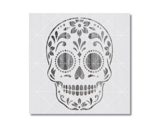 A stylized black and white illustration of a skull with intricate floral and geometric patterns decorating the top.