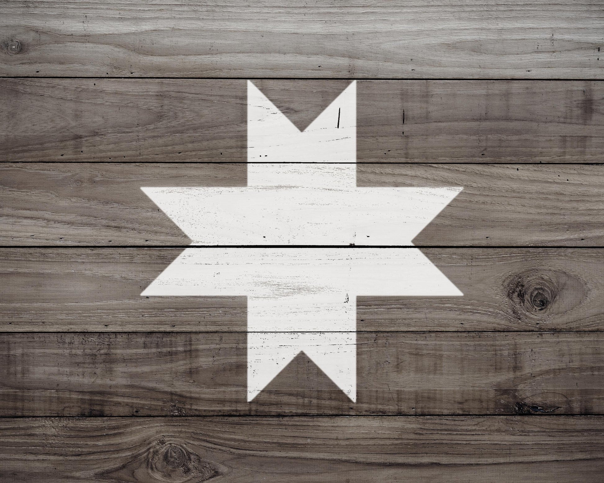 a wooden surface with a white star-shaped design in the center.