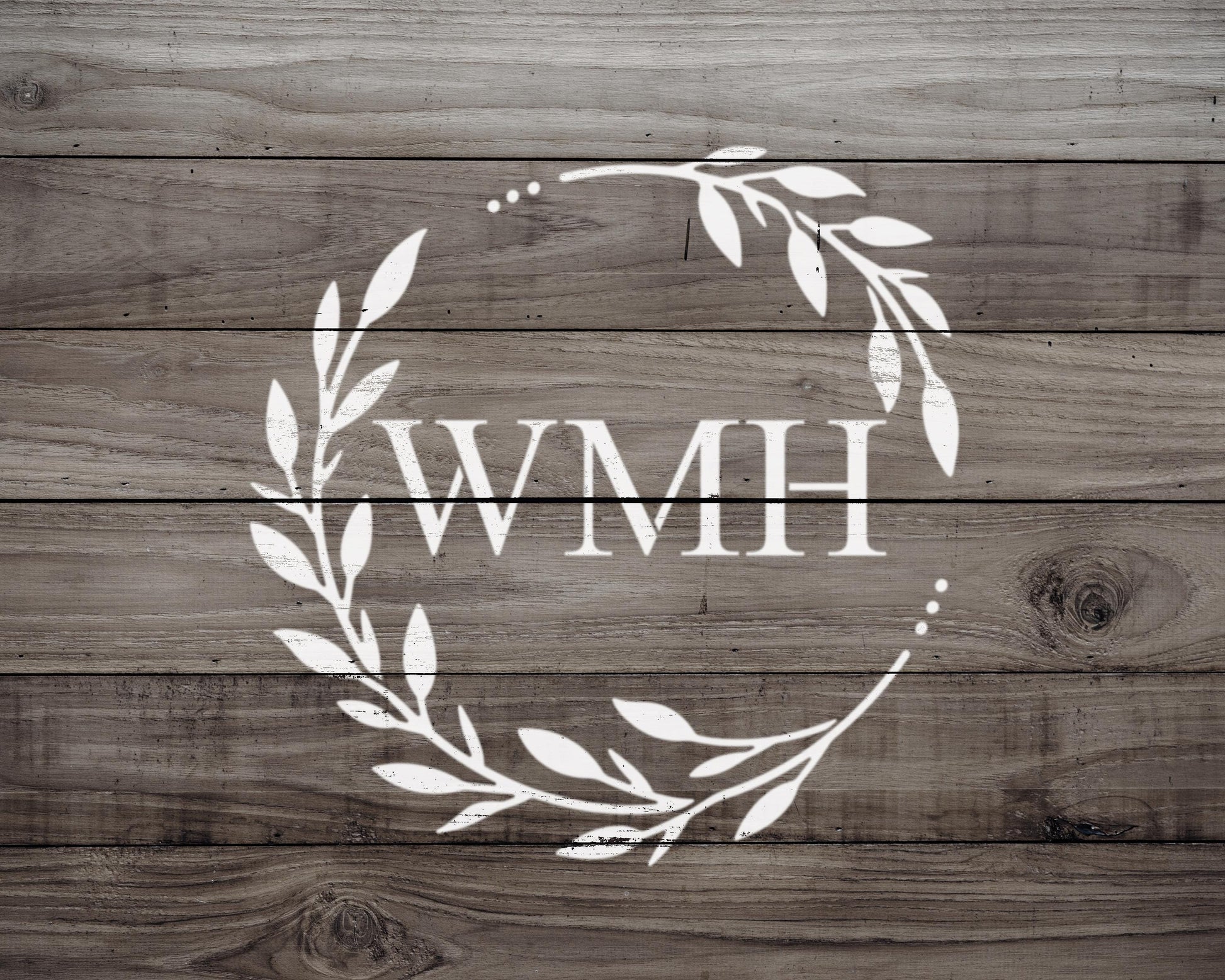 a wreath-like design with the letters "WMH" prominently displayed in the center.