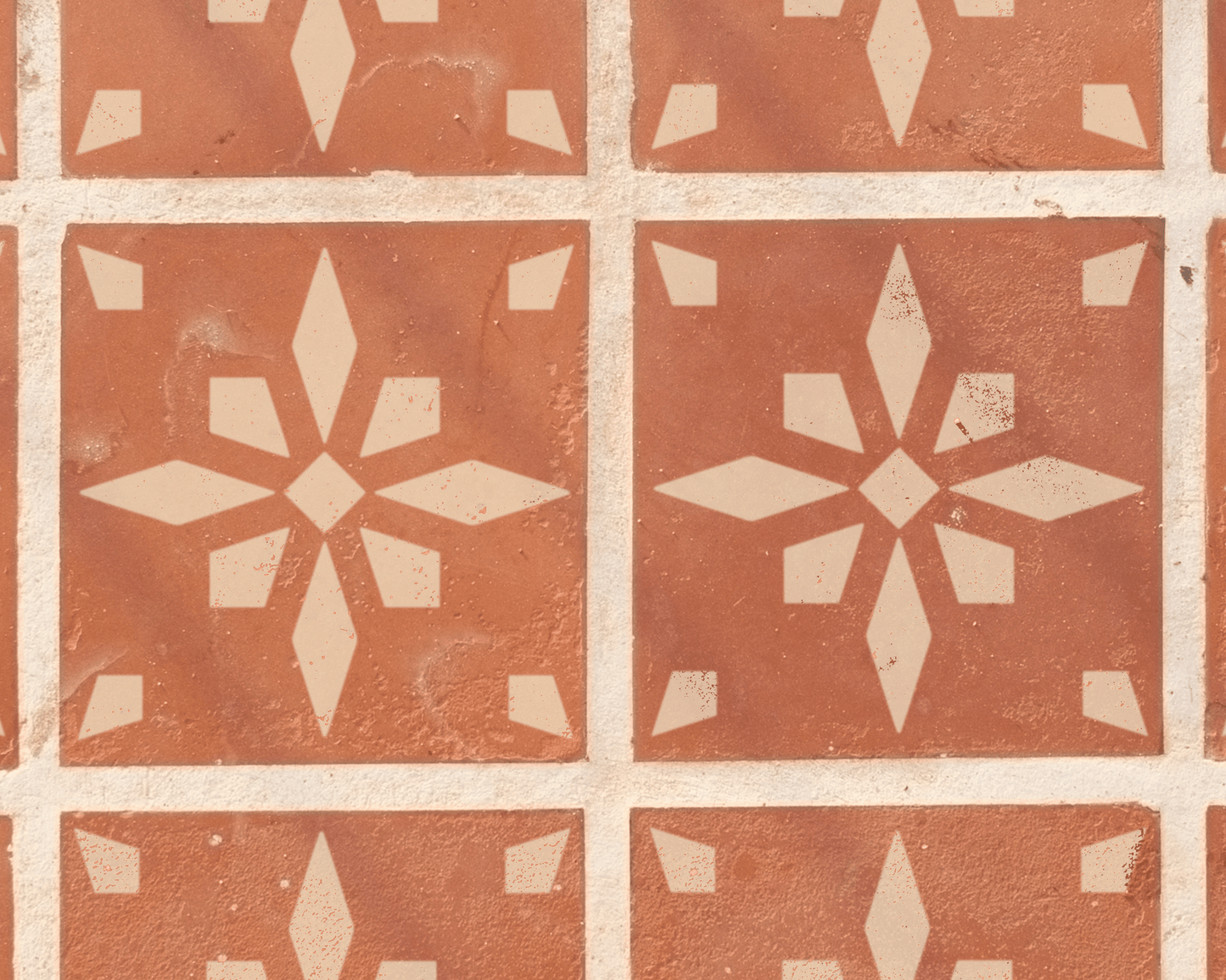 a pattern of red and white tiles arranged in a grid-like design, featuring a central star-shaped pattern.