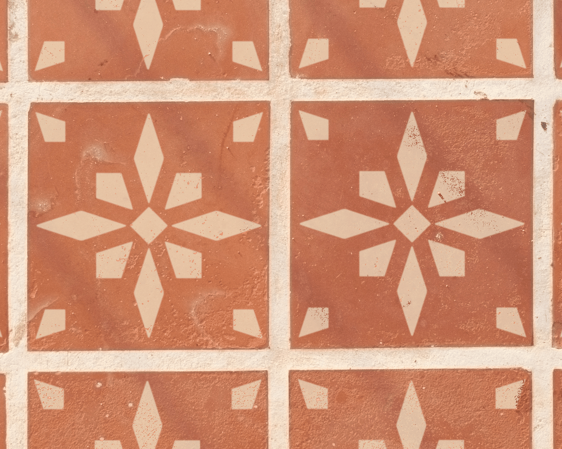 a pattern of red and white tiles arranged in a grid-like design, featuring a central star-shaped pattern.