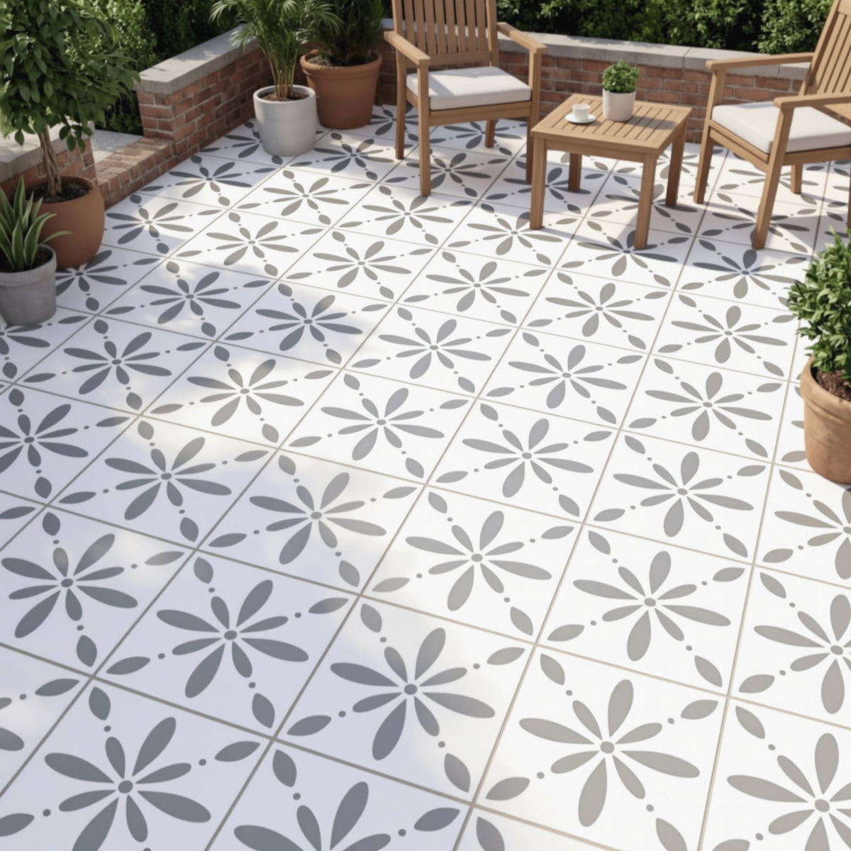 a patio area with a tiled floor and wooden chairs arranged around a table. The patio is decorated with potted plants, creating a cozy and inviting atmosphere.