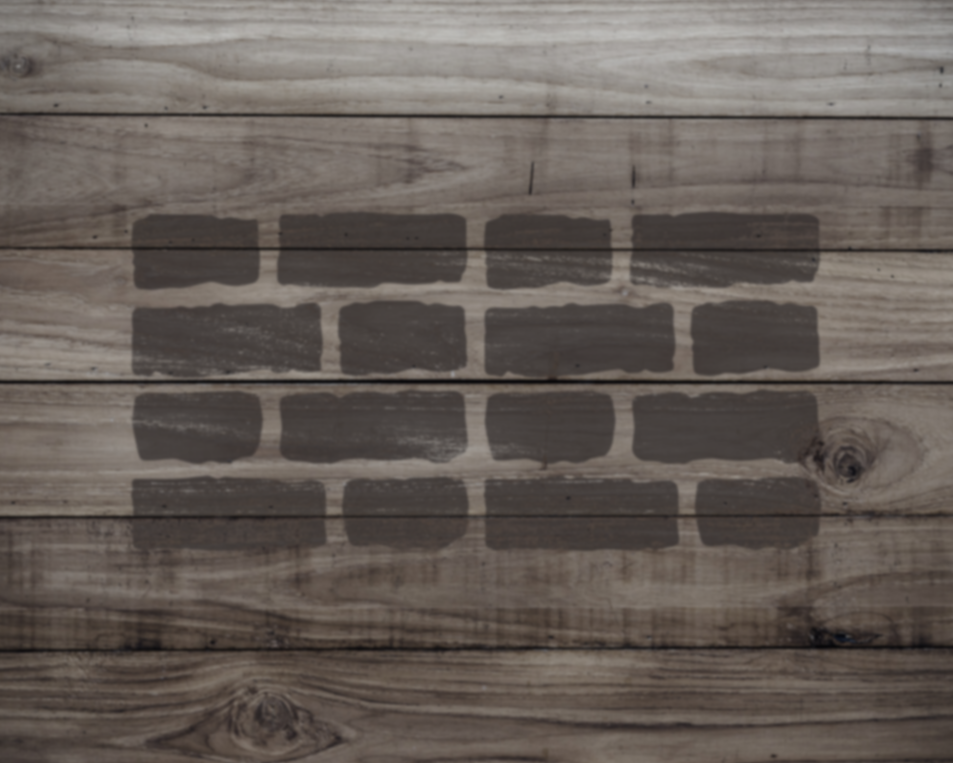 a wooden surface with a pattern of dark gray bricks or blocks arranged in a repeating pattern.