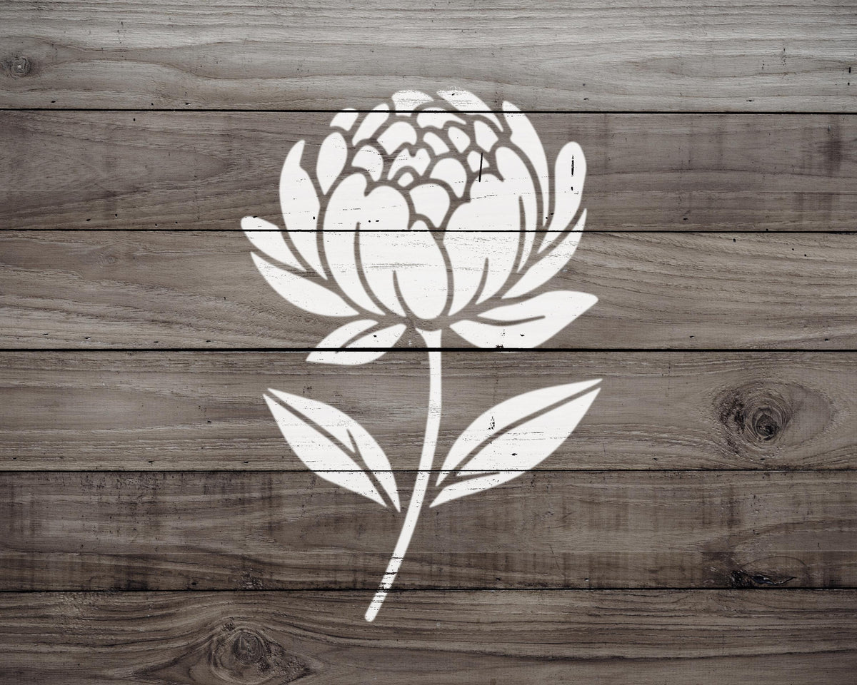 A white flower with a large center is depicted on a wooden background.