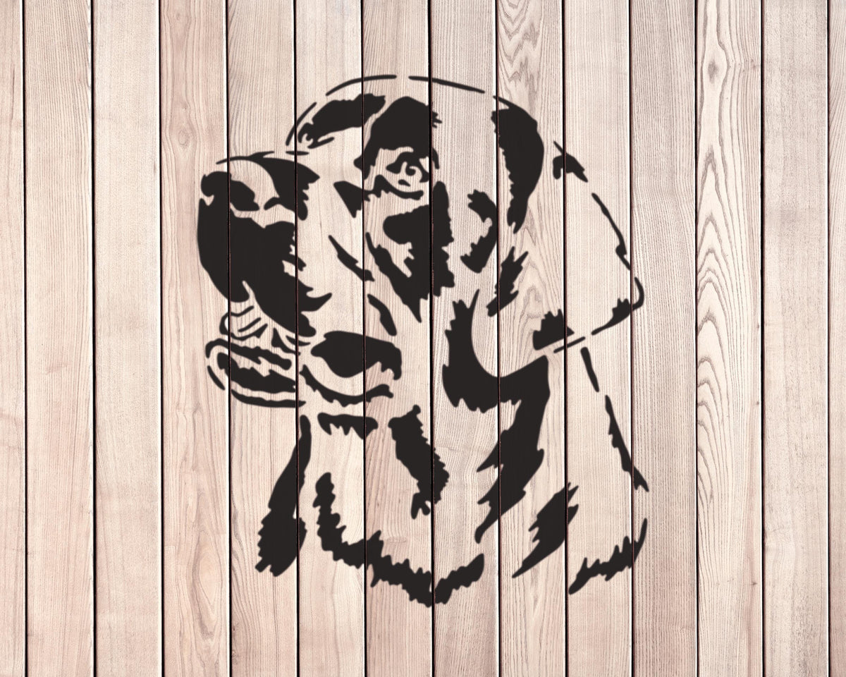 A black and white silhouette of a dog's head is displayed against a wooden background.