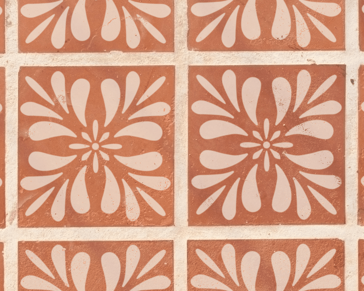 a repeating pattern of white floral designs on a reddish-brown background.