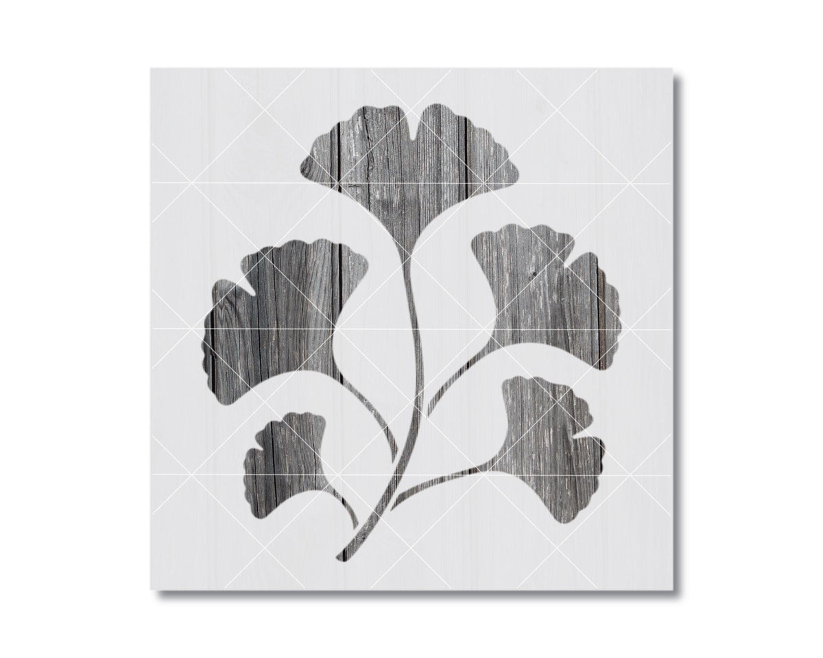 A black and white image depicting a stylized ginkgo tree with its leaves and branches.