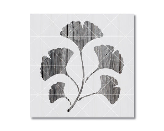 A black and white image depicting a stylized ginkgo tree with its leaves and branches.