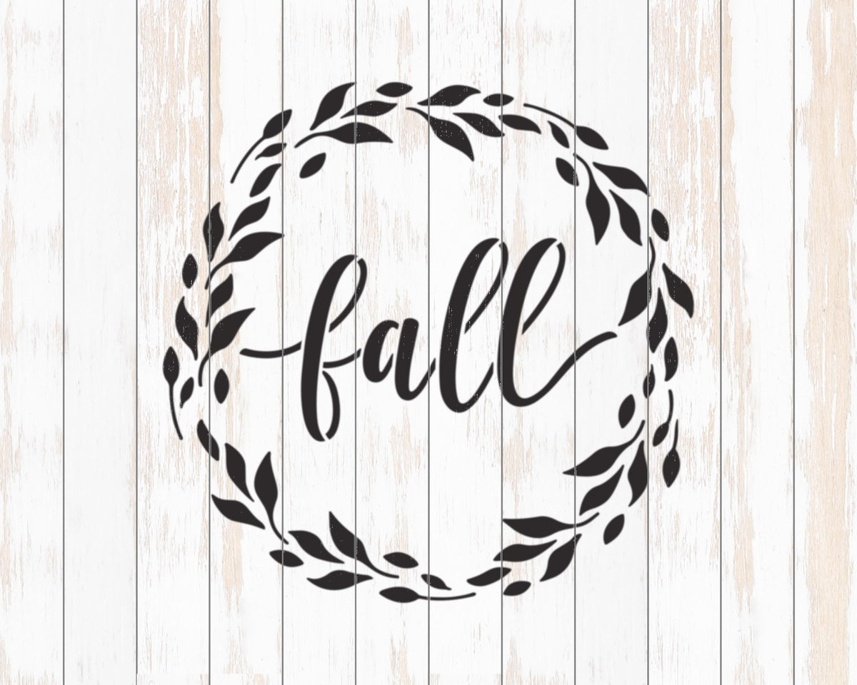 a wreath with the word "fall" written inside it, set against a white wooden background with a distressed texture.