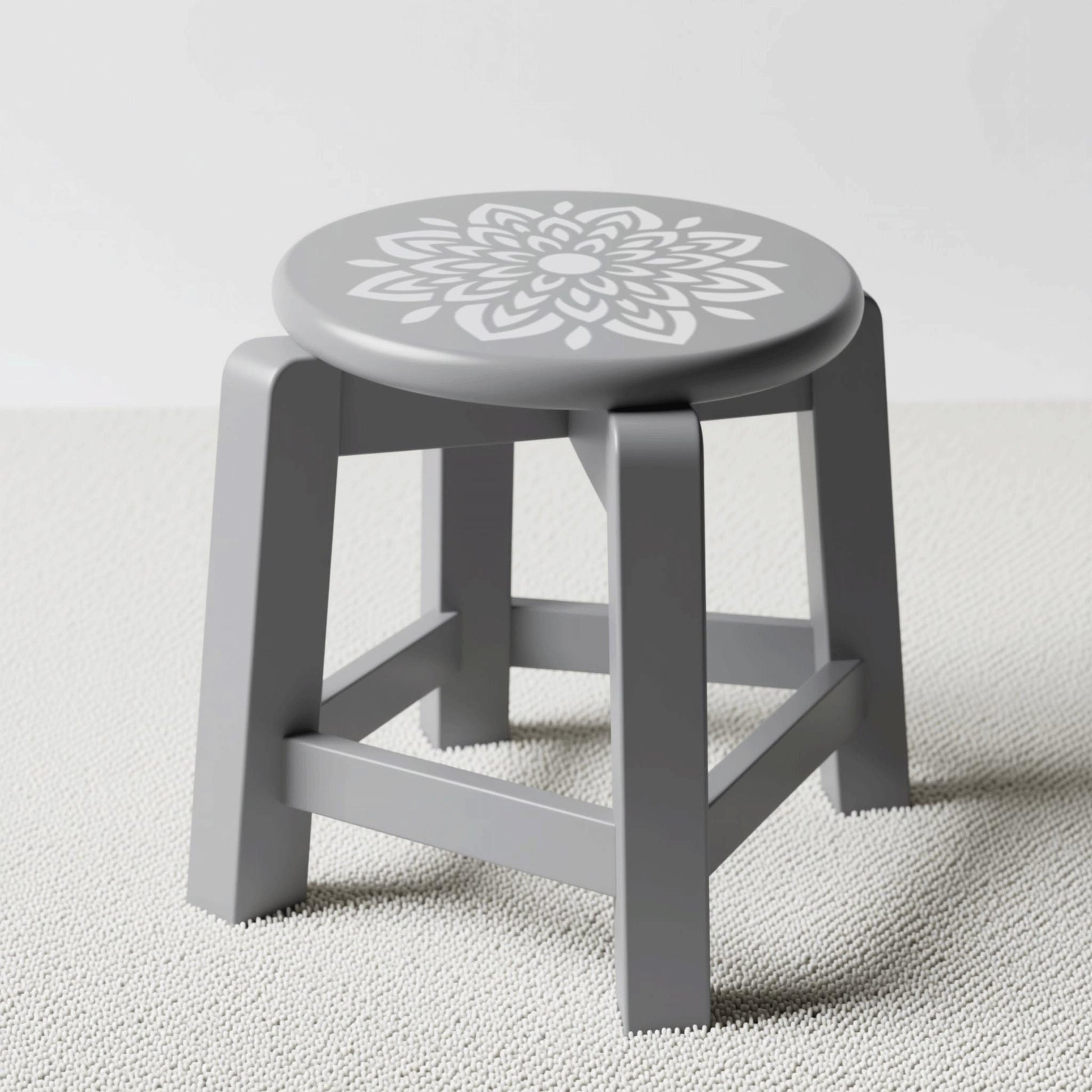 A gray stool with a white floral design on the seat.
