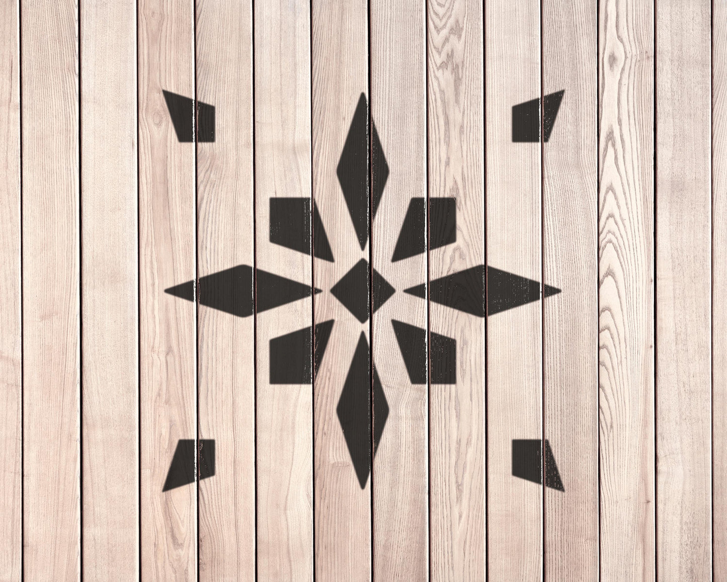 a wooden wall with a black geometric pattern in the center.
