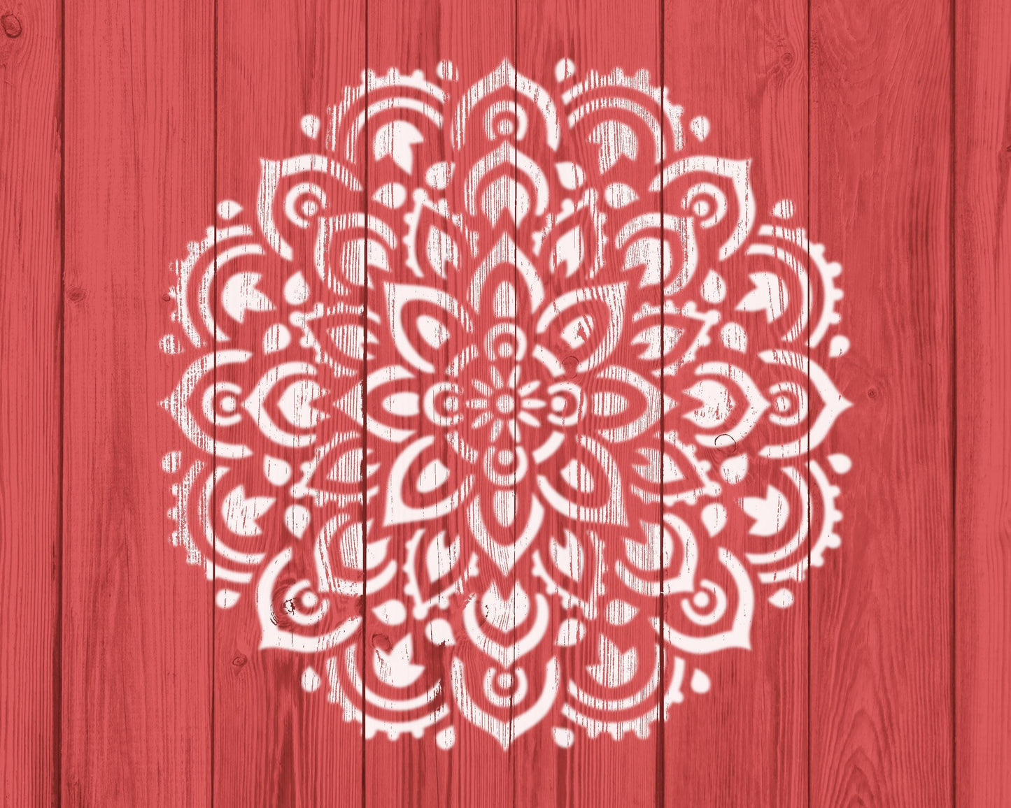 a red wooden background with a white, intricate mandala-like design painted on it.