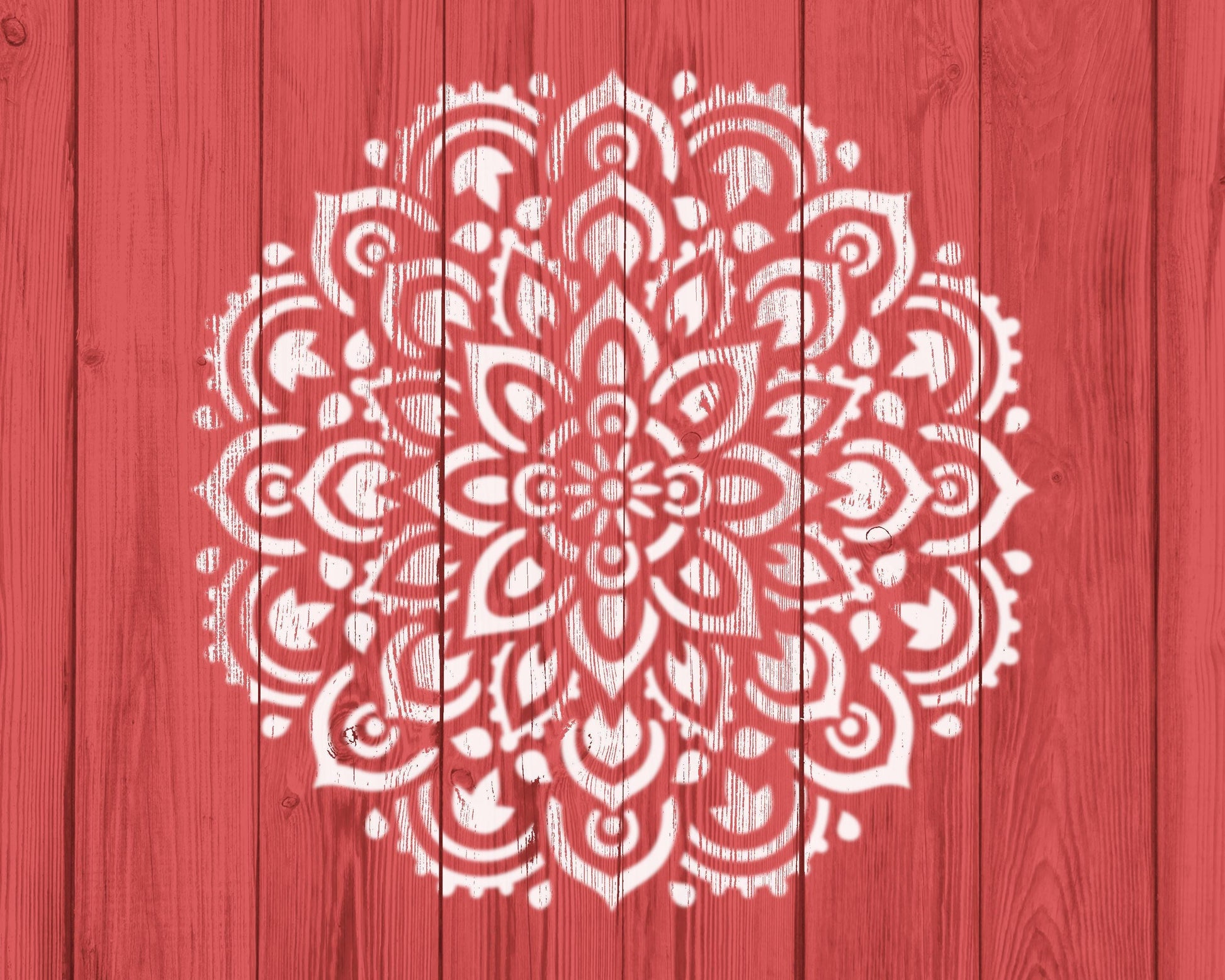 a red wooden background with a white, intricate mandala-like design painted on it.