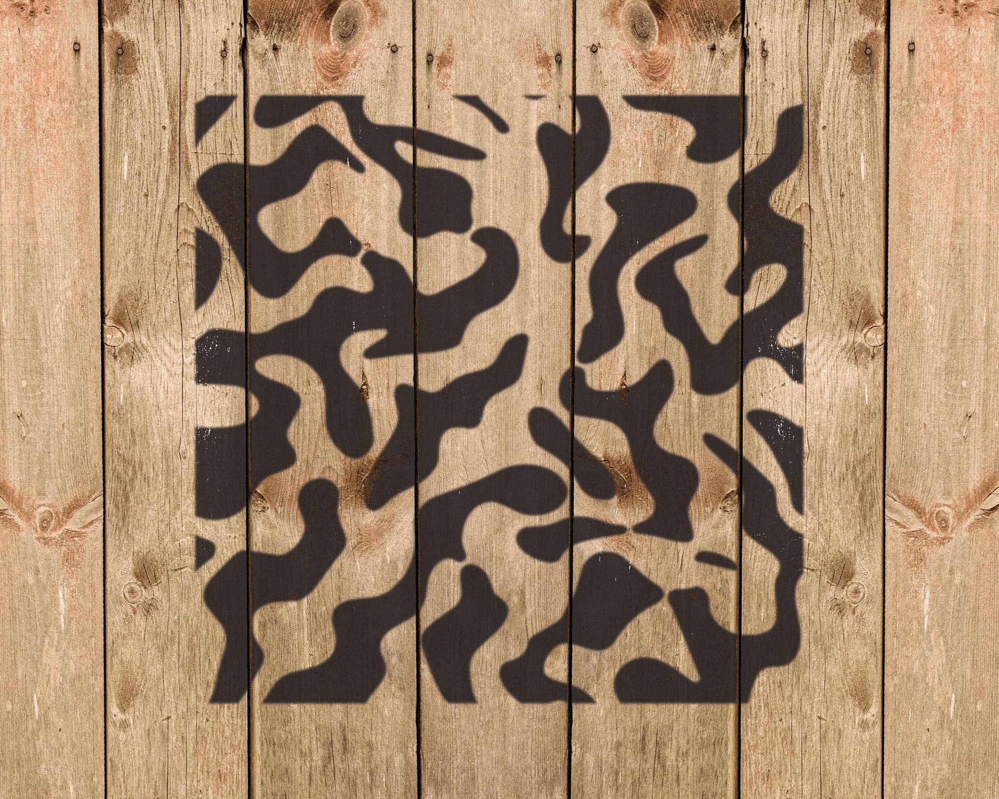 a wooden background with a black and white camouflage pattern.
