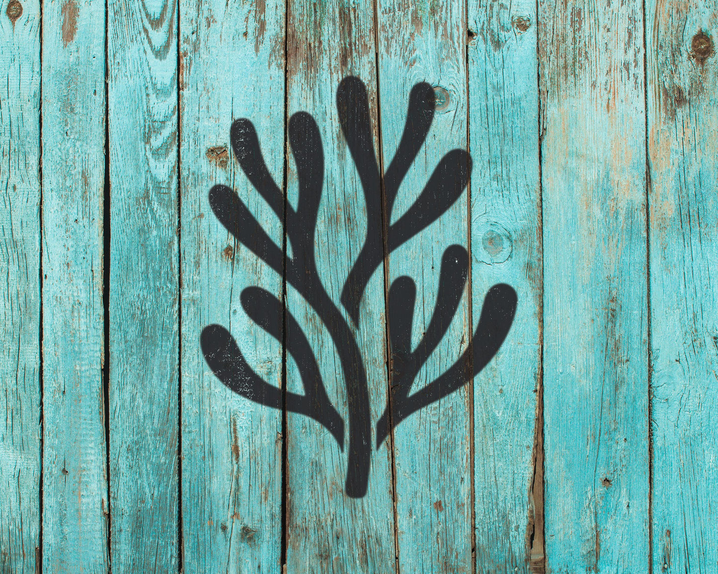a stylized black silhouette of a plant or tree against a blue wooden background.