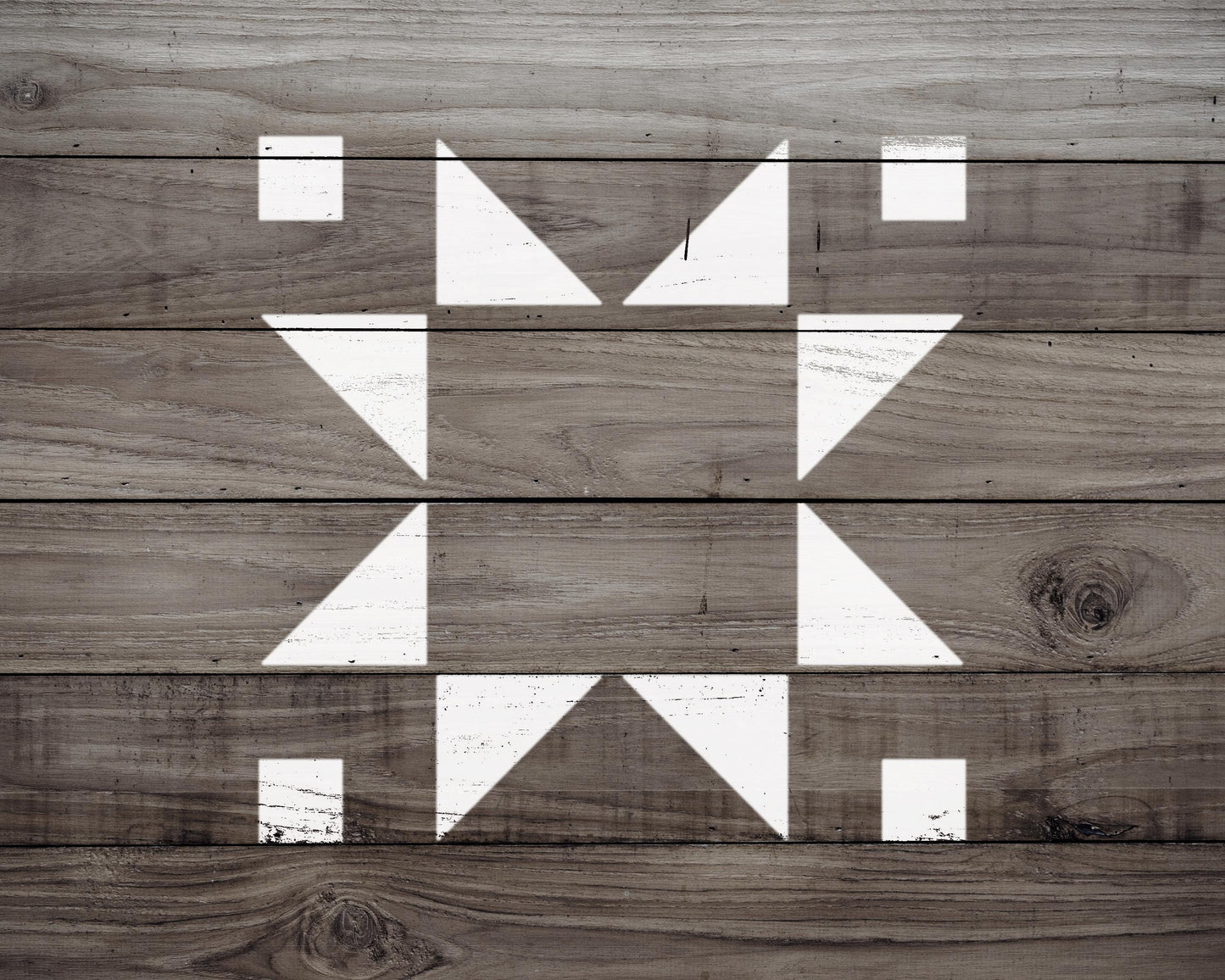 a close-up view of a wooden surface with a geometric pattern of white triangles arranged in a diamond shape.