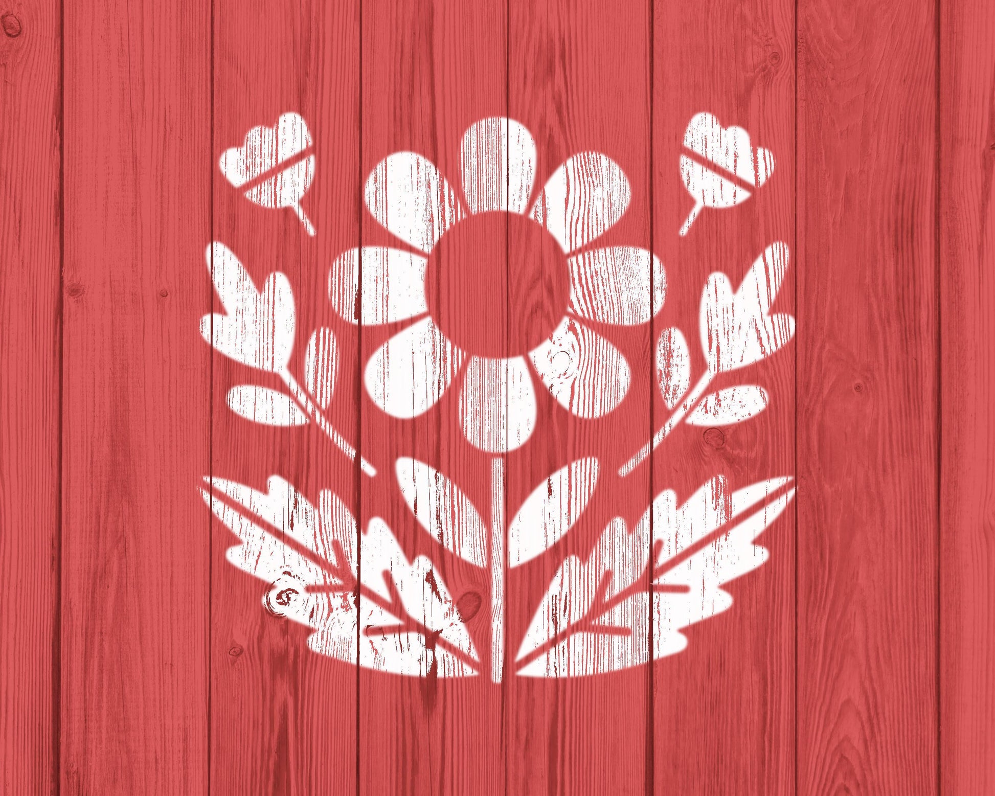 A white flower design with leaves is centered against a red wooden background.