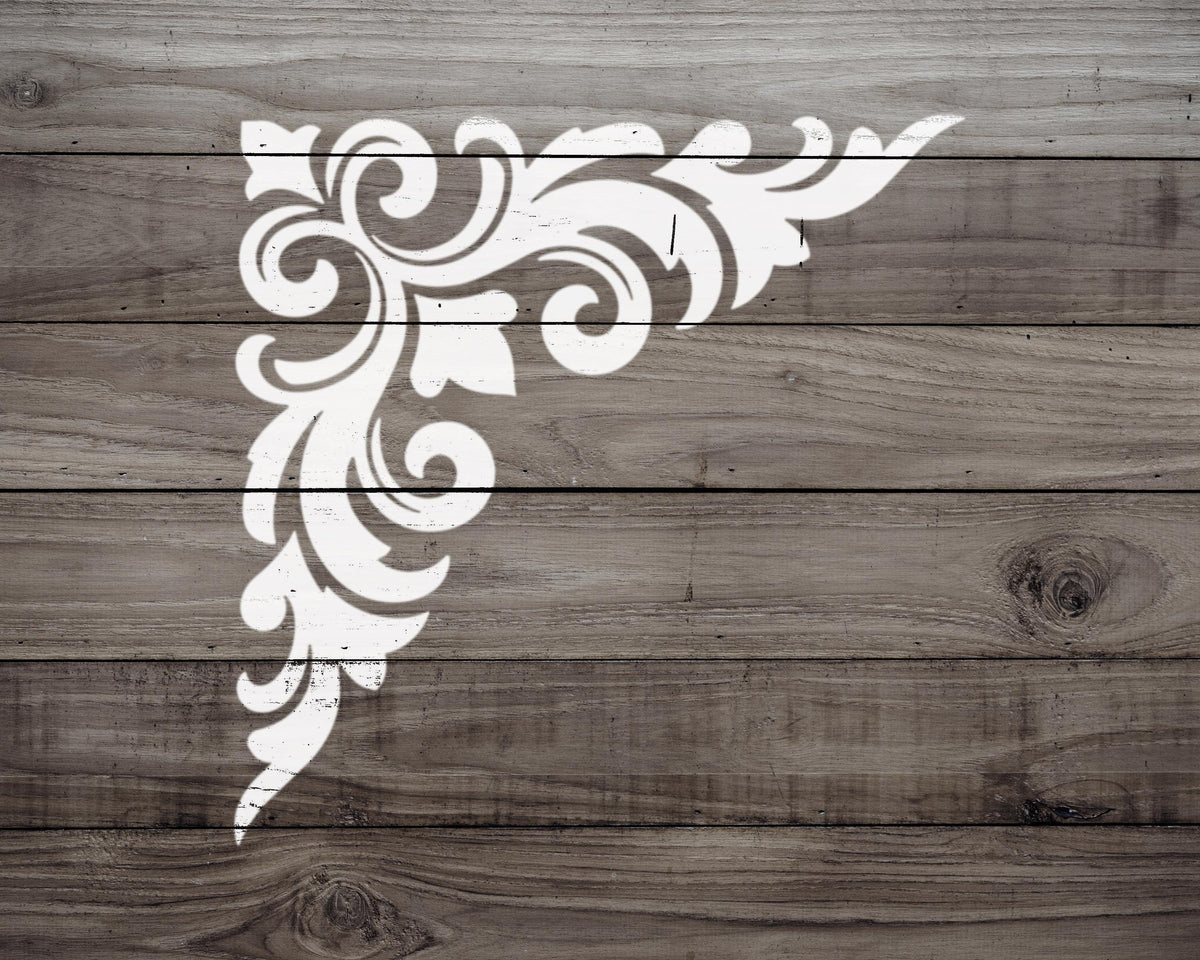 a decorative white design on a wooden surface.