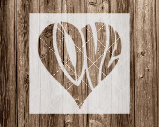 A heart-shaped stencil with the word "LOVE" written inside it, against a wooden background.
