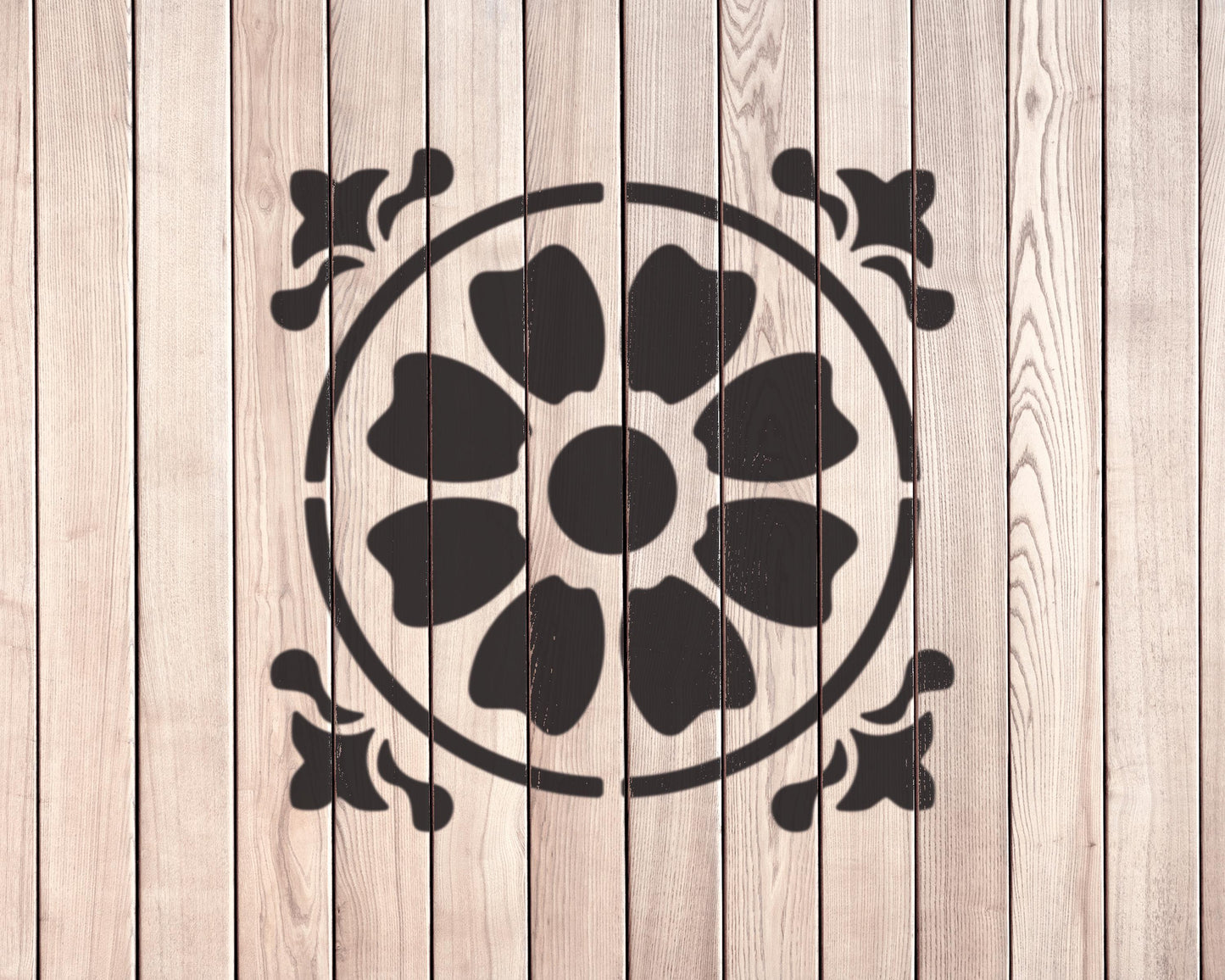 a wooden wall with a black floral design in the center.