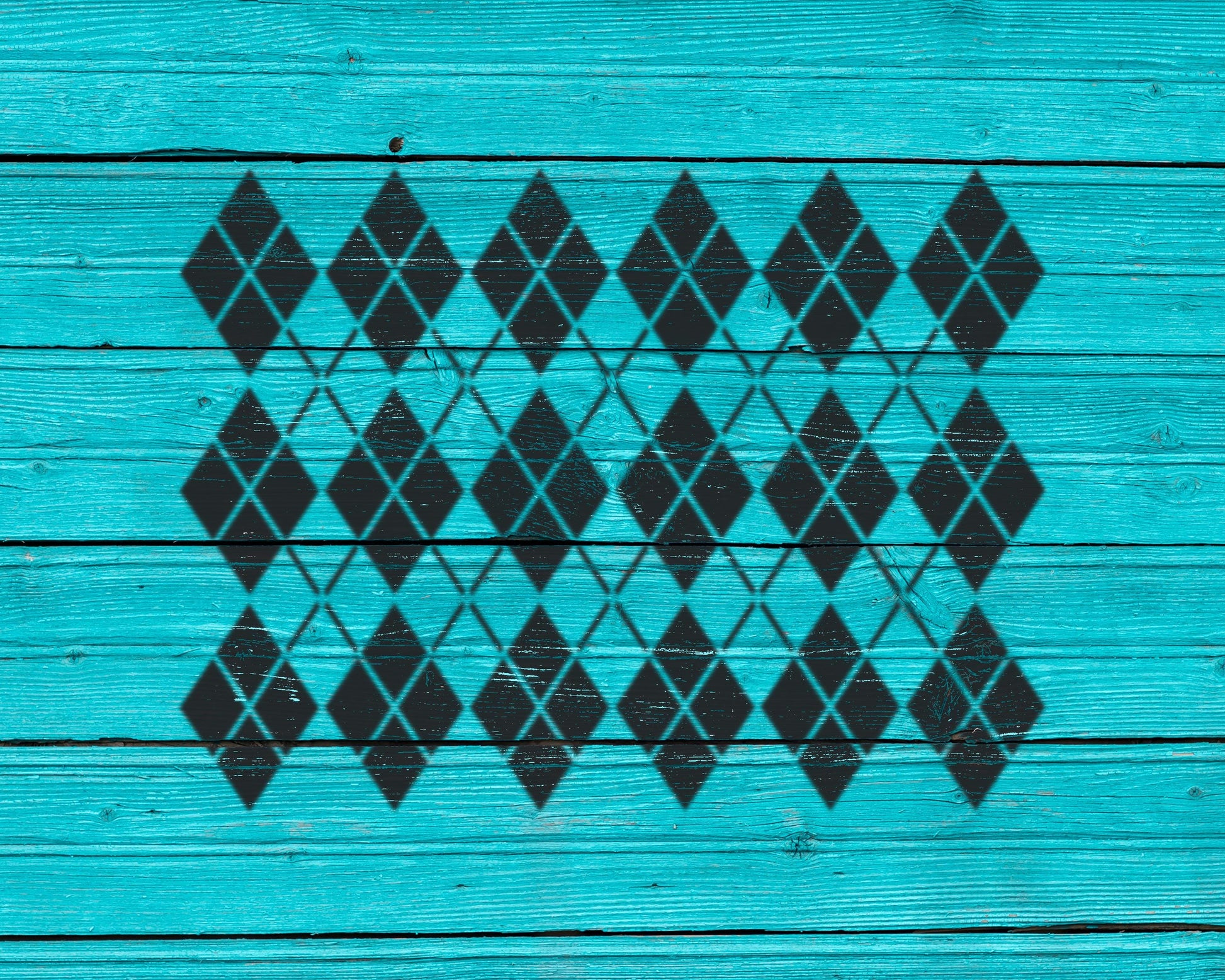 a pattern of black diamond shapes on a turquoise wooden surface.