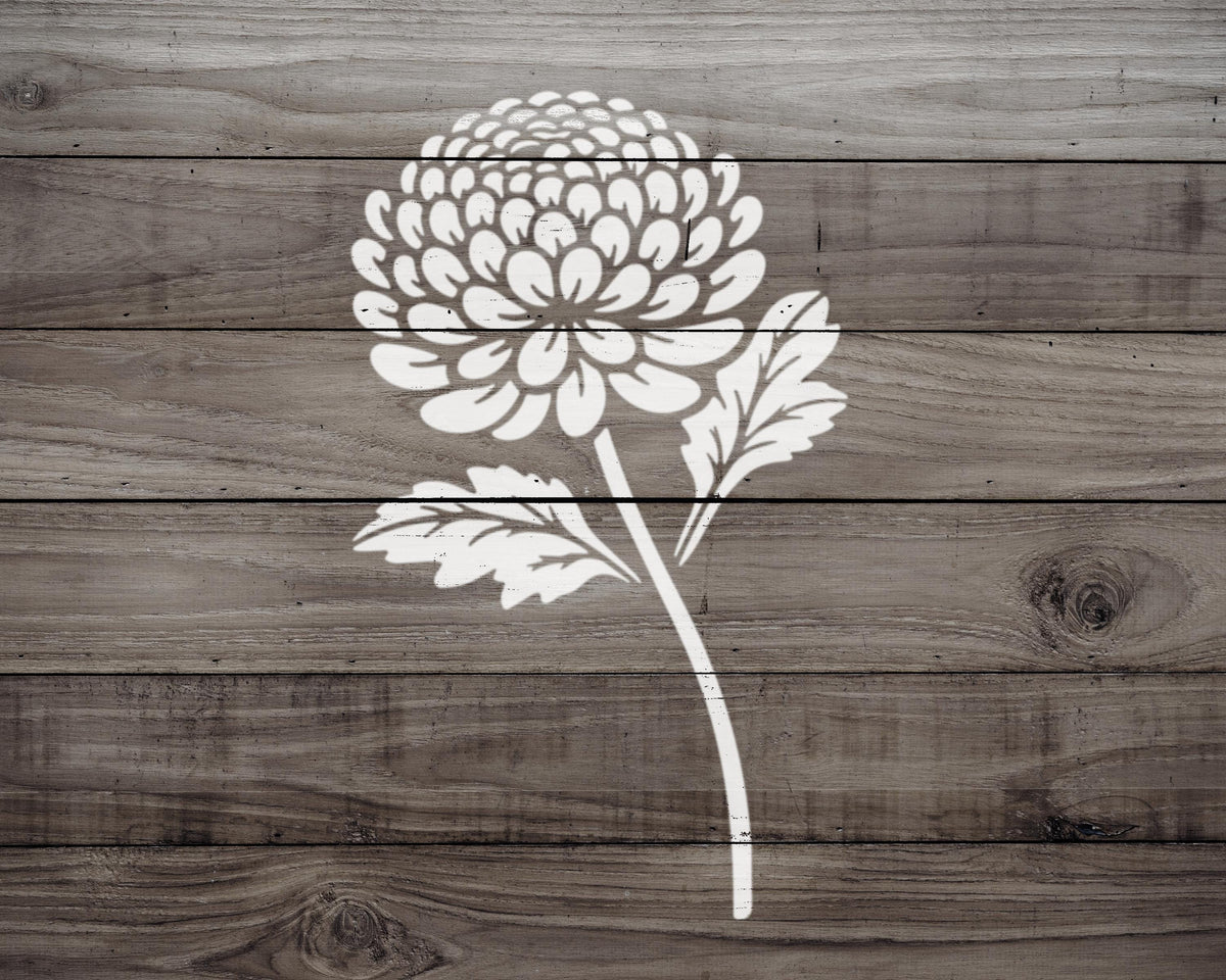 A white flower with a large center is depicted on a wooden background.