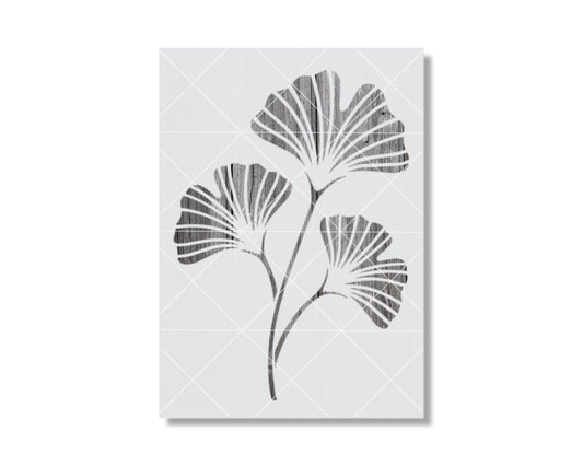 A black and white image depicting three stylized ginkgo leaves with intricate, overlapping patterns.
