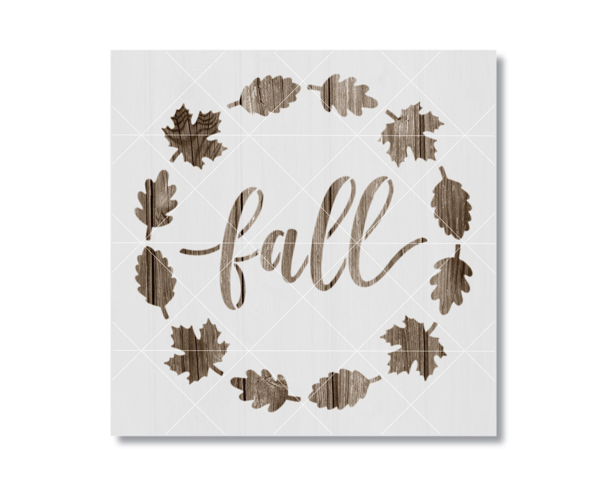 a wreath made of wooden leaves surrounding the word "fall" written in a cursive script.