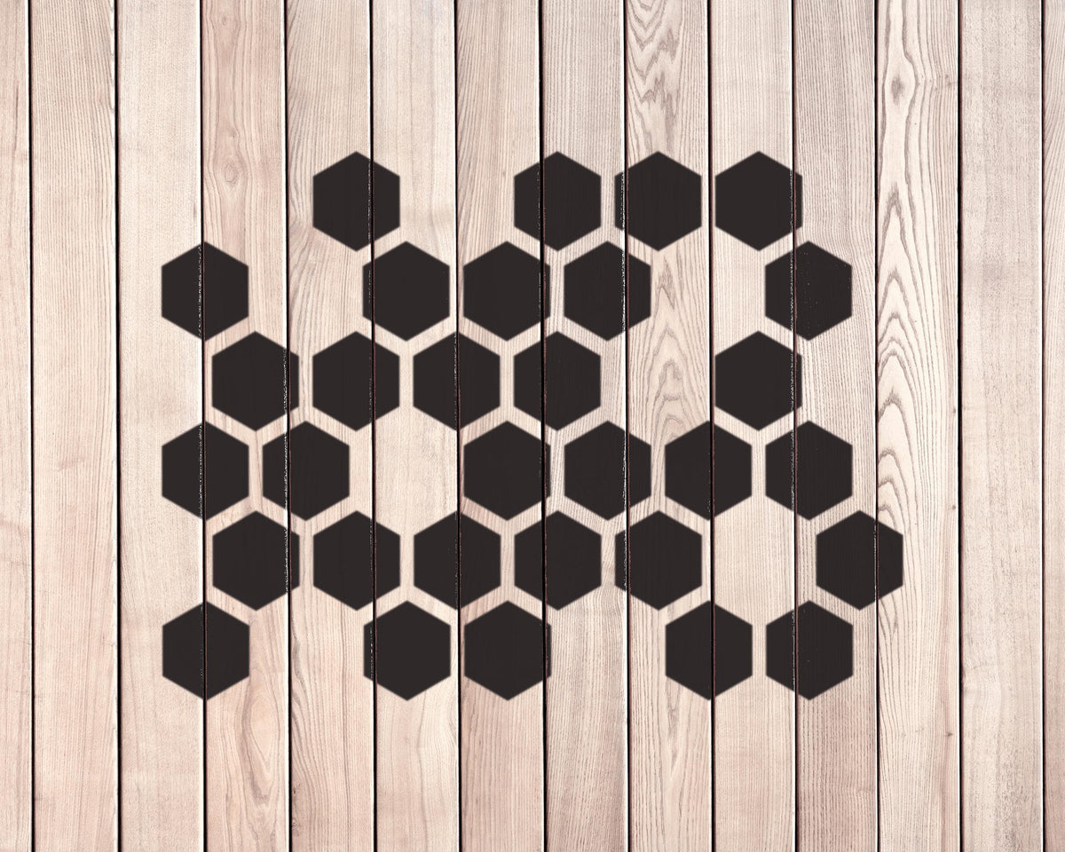a wooden surface with a repeating pattern of black hexagons.